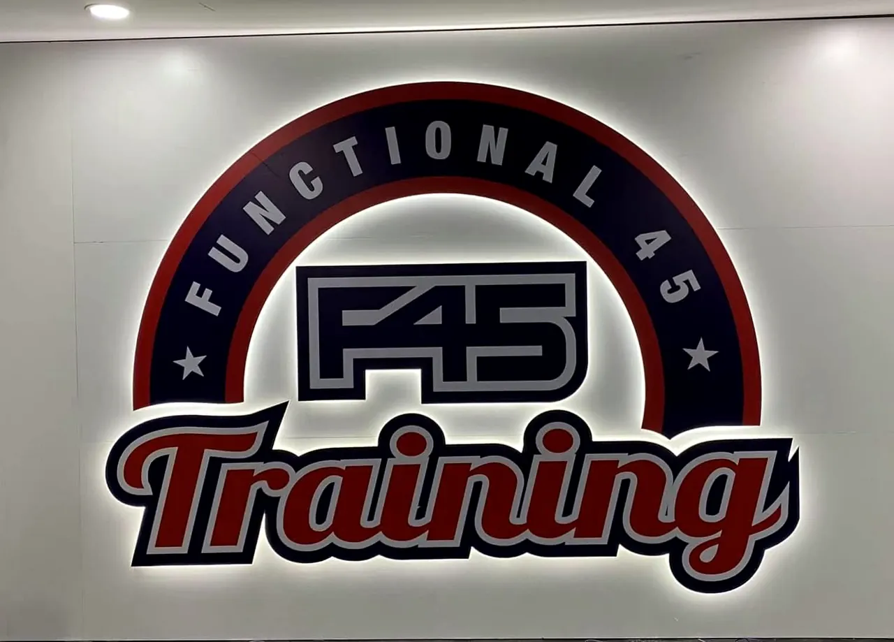 F45 Training logo wall with printed acrylic faces and a white LED halo behind the letters.